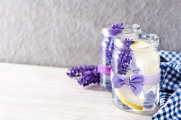 Obraz na płótnie Canvas Lavender lemonade drink on white wooden table. Copyspace