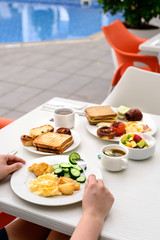 English breakfast: fried egg, bacon, beans and toast on a plate close-up. horizontal view from above