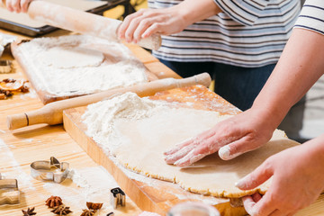 Bakery food cooking class. Closeup of women hands preparing dough for making gingerbread biscuits.