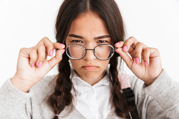 Photo closeup of frustrated angry girl wearing eyeglasses frowning and expressing aversion with face