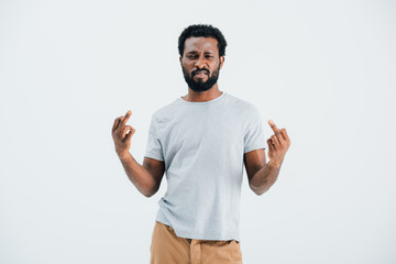 Fototapeta premium beard african american man in grey t-shirt showing middle fingers isolated on grey