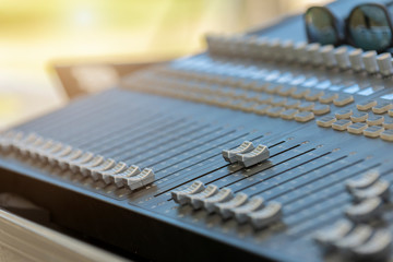 Closeup of the professional audio digital mixing console. Selective focus