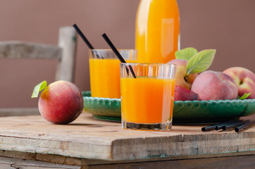 Fresh homemade peach juice in glass for breakfast on wooden table .Rustic stile. Free text space.