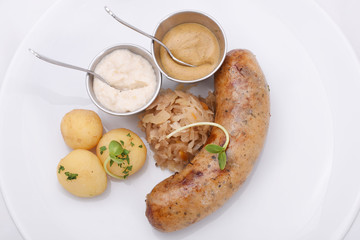Homemade sausage with boiled baby potatoes and fried cabbage. served with horseradish and mustard sauces. German, Russian, Ukrainian cuisine