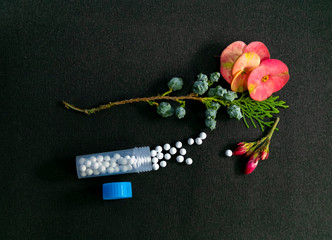Closeup image of Homeopathic medicine with a bottle containing sugarball of homeopathic substance...