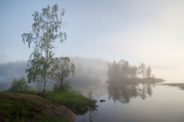 Fototapeta na wymiar Foggy morning landscape on the lake, Valaam Island, Karelia, Russia.