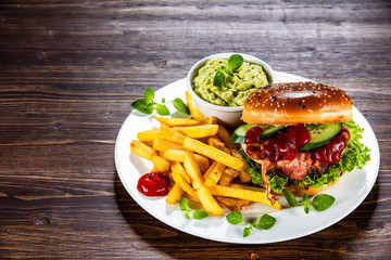 Tasty burger with chips served white plate