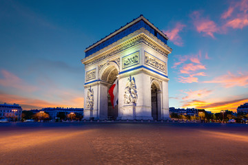 Arc de Triomphe de Paris at night in Paris, France.