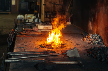 Blacksmith forge with fireplace and metal tools