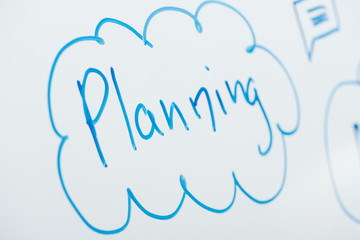 close up view of word planning written on white flipchart