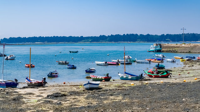 Larmor-Baden beach in Brittany, typical boats, and the colorful ship to Gavrinis island on the pier