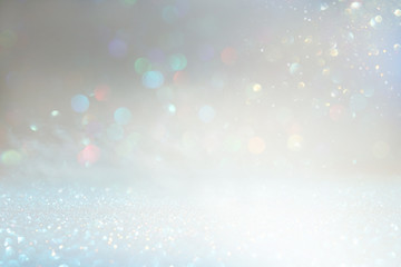 glitter vintage lights background. silver and white. de-focused
