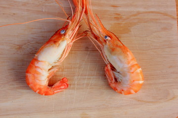 Shrimp is cooked  placed on a brown wood floor. 