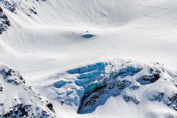 Fototapeta na wymiar back country skier uphill tracks in the snow above the glaciers crevasse