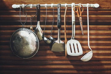 kitchen utensils hanging on the cabinet door