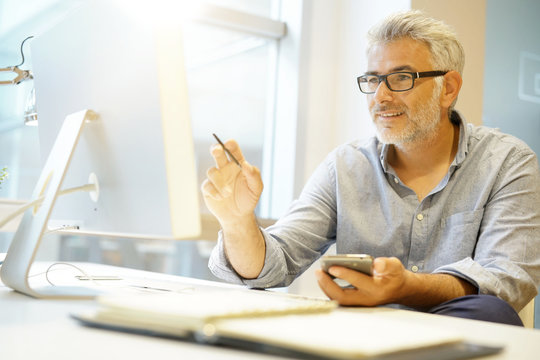 Smart casual businessman working in contemporary office