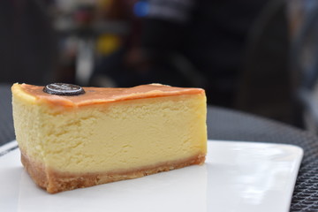 A piece of cheesecake is on white plate.