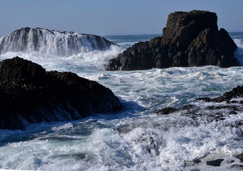 The waves crashing on the rocks