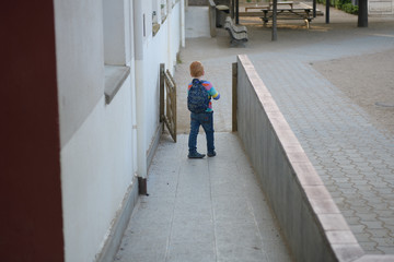 Fototapeta na wymiar 5 years old redheaded boy going to school
