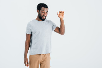 african american man in grey t-shirt waving isolated on grey