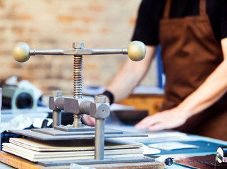 Detail of paper press on working table