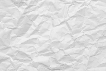 Modern crumpled white paper on empty sheet gray background with light shadows for creative wallpaper, card, art work design.