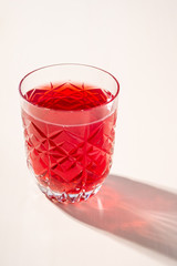 Stewed fruit red compote drink in textured transparent glass