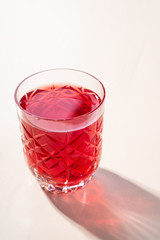 Stewed fruit red compote drink in textured transparent glass