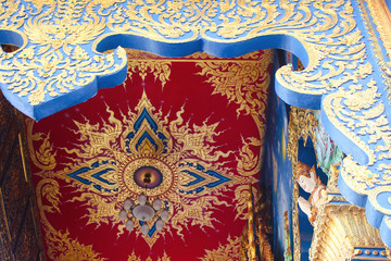 Detailed and colorful painted ceiling on the interior of Blue Temple, Wat Rong Seua Ten, seen from outside. Chiang Rai