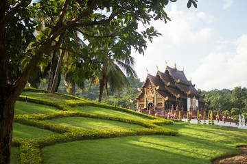 Natural framing photo of Ho Kham Luang pavilion, or Grand Pavilion, surrounded by garden and trees. Royal Park Rajapruek