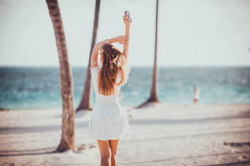 summer vacation beach travel photo -  young blonde sexy girl in dress enjoying sunbathing on sea...