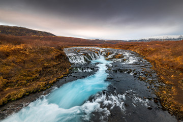 Landscape in Iceland waterfall sun mountains light golden hour road