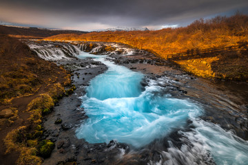 Landscape in Iceland waterfall sun mountains light golden hour road