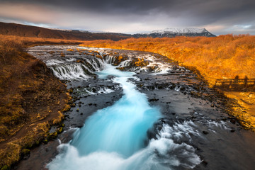 Landscape in Iceland waterfall sun mountains light golden hour road