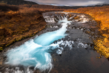 Landscape in Iceland waterfall sun mountains light golden hour road
