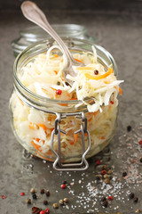 Homemade sauerkraut with carrots in jar .Vegetarian  food. Top view 