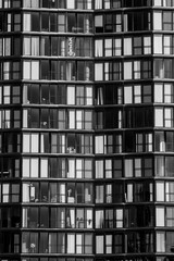 light and dark apartment or office building windows - 274460405
