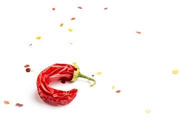 Dried chili peppers with ground pepper on a white background. Isolated