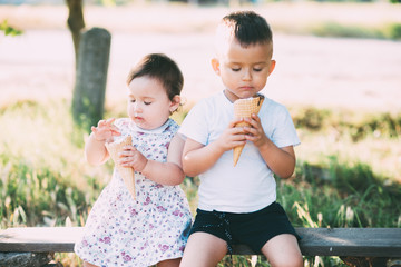 Cute kids Brother and sister Eating ice cream in summer outside is very cute