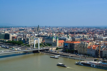 Naklejka premium 12.06.2019. Budapest, Hungary. A view of the new, wide and modern bridge through the Danube River of white color. Traffic intersection. Cars.
