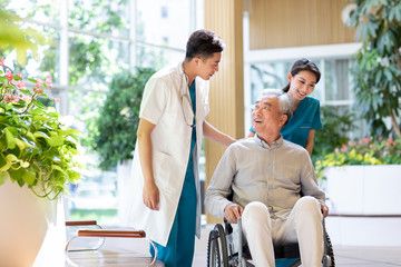 Young doctor talking with patient in nursing home