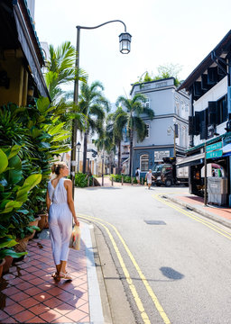 Girl Tourist Walks The Streets Of Singapore And Admires The Views