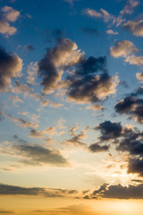 Landscape with dramatic light - beautiful golden sunset with saturated sky and clouds.