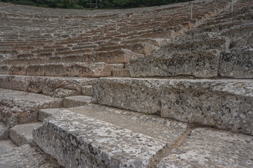 Fototapeta na wymiar Epidaurus, Greece: Close-up of the seats at the ancient theater of Epidaurus, designed by Polykleitos the Younger in the 4th century BC.
