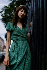 Fototapeta premium young woman in green dress looking into the camera
