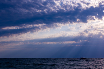 Amazing sea sunset on the pebble beach, the sun, waves, clouds