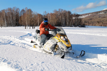 Athlete on a snowmobile.