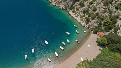 Aerial photo of tropical exotic island bay with beautiful emerald sea and deep blue cloudy sky