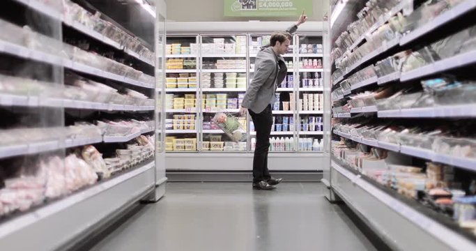 Adult male dancing in a grocery store