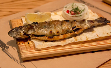 Fish trout for dinner, on a wooden plate